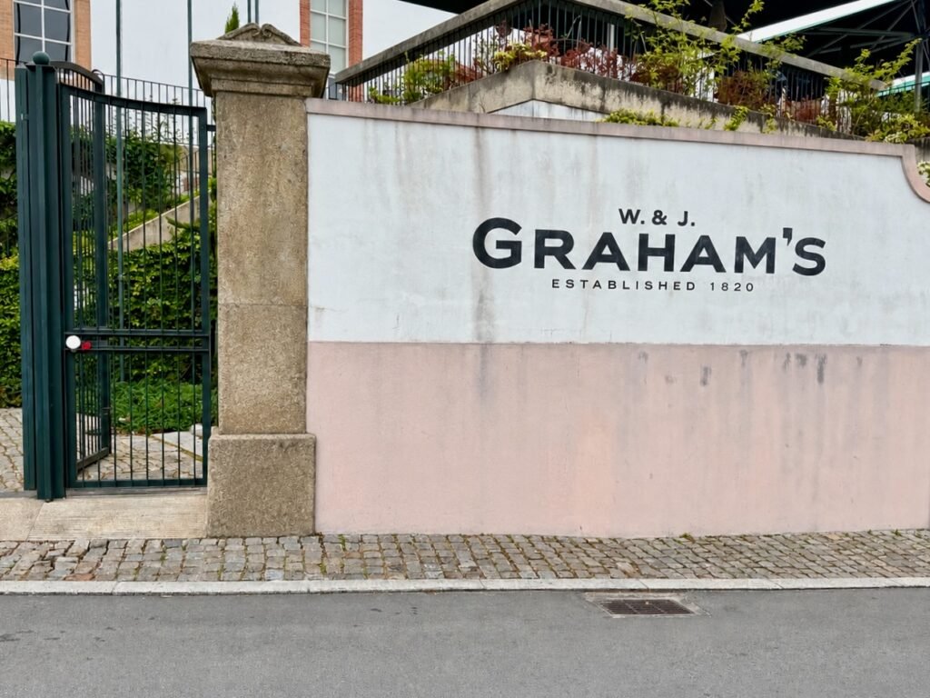 Del blanco al ámbar: una tarde en Graham's Entrada de Graham's Port Lodge en Vila Nova de Gaia, con el letrero W. & J. Graham's, establecido en 1820